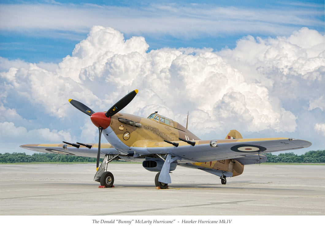 Hawker Hurricane parked with clouds in the background.